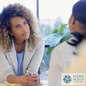 image of a young female listening to what appears to be another female - we only see their back - for the blog How Can a Patient Advocate Help Me?